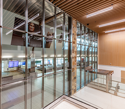 Large span of architectural glass dividing airport security from the terminal. 