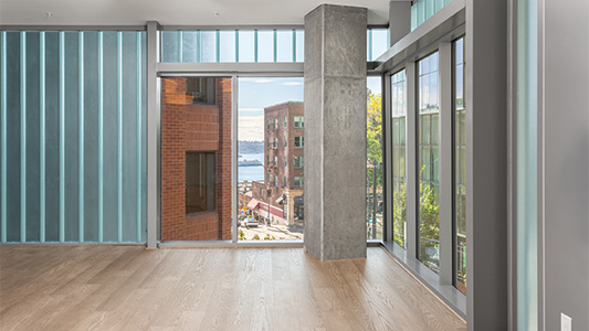 Translucent channel glass illuminates the fitness studio at The Emerald in Seattle