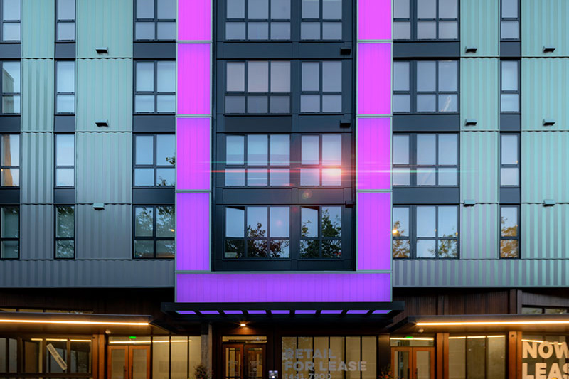 Center Steps Apartments’ translucent channel glass façade with LED lit rectangular beacon.
